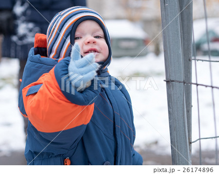 Attractive baby boy playing with the first snow Attractive baby boy playing with the first snow 26174896