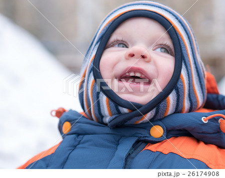 Attractive baby boy playing with the first snow Attractive baby boy playing with the first snow 26174908