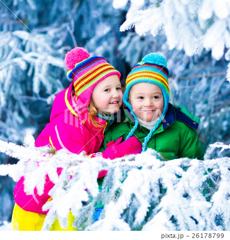 Kids playing in snowy forest Kids playing in snowy forest 26178799