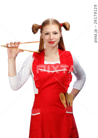 Young housewife in bright red apron with funny ponytails holding 26179129