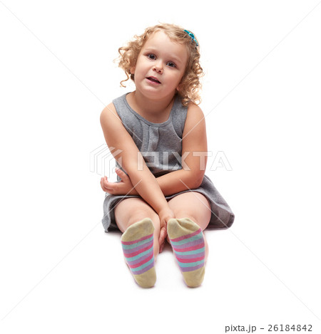 Young little girl sitting over isolated white Young little girl sitting over isolated white 26184842
