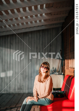 young modern girl on veranda. sunset evening in 26187854