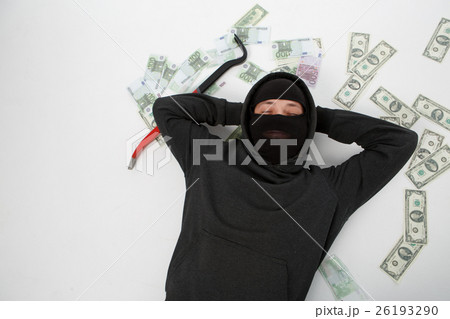 Robber on floor with money 26193290