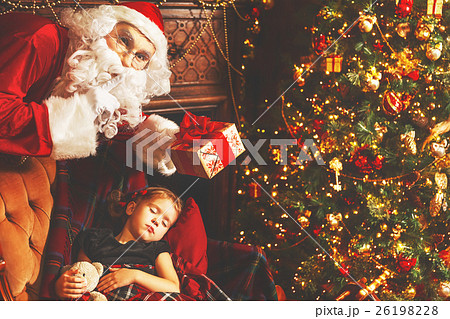 Santa Claus presents Christmas gift to sleeping child girl in Ch 26198228