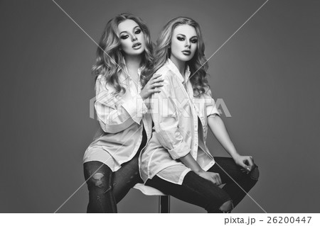 Two beautiful girls in white shirts and jeans Two beautiful girls in white shirts and jeans 26200447