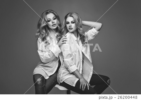 Two beautiful girls in white shirts and jeans Two beautiful girls in white shirts and jeans 26200448