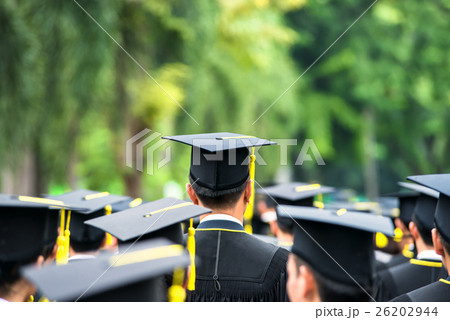 Back of graduates during commencement . 26202944