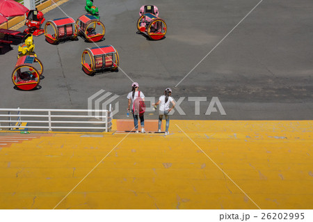 Two girls down the stairs. 26202995