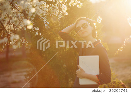 Girl with a laptop in park 26203741