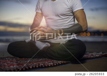 Man sitting in lotus position on the beach Man sitting in lotus position on the beach 26205933