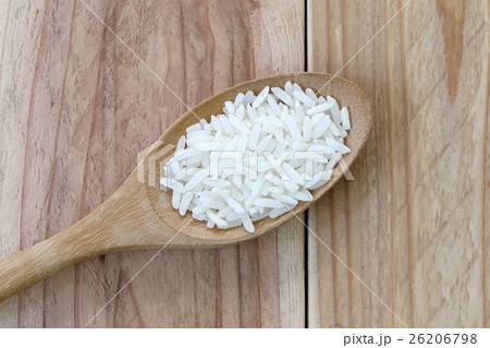 Organic jasmine rice in wooden spoon. Organic jasmine rice in wooden spoon. 26206798