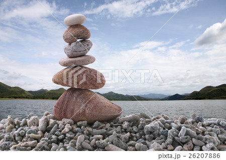 Balance stone on pile rock with river background. Balance stone on pile rock with river background. 26207886