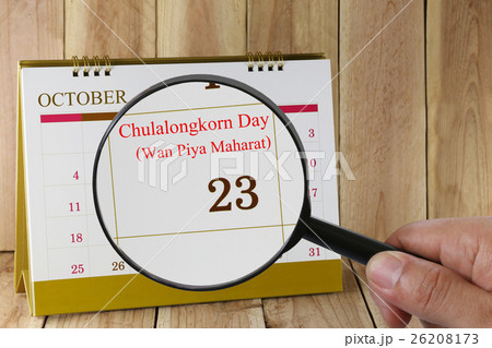 Magnifying glass in hand on calendar you can look Twenty-three days of October,Wan Piya Maharat. 26208173