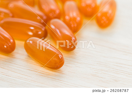 Close up Gel capsule on wooden table Close up Gel capsule on wooden table 26208787