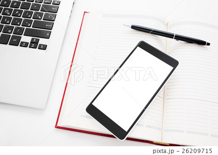 Smartphone with blank screen on office stuff 26209715