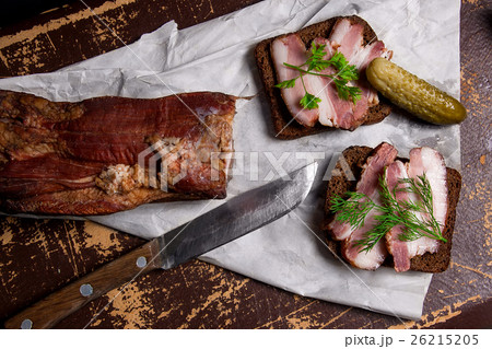 Smoked bacon with black bread and several pickles 26215205