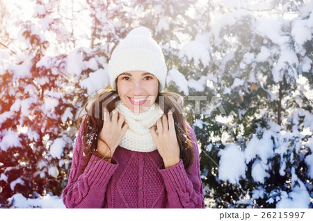 happy young woman in a white knitted hat and scarf happy young woman in a white knitted hat and scarf 26215997