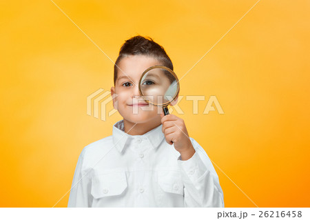 Little boy using magnifier looking close up Little boy using magnifier looking close up 26216458
