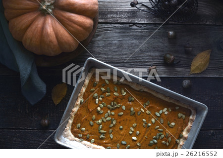 Pumpkin pie on the wooden table with autumn gift Pumpkin pie on the wooden table with autumn gift 26216552