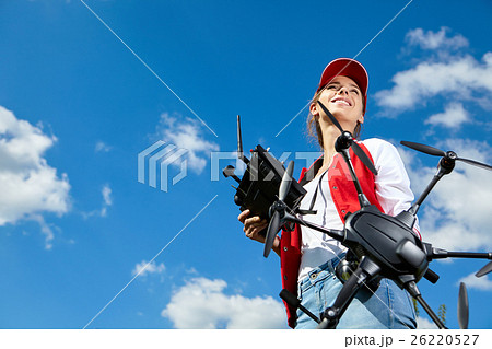 Woman is standing and holding drone 26220527