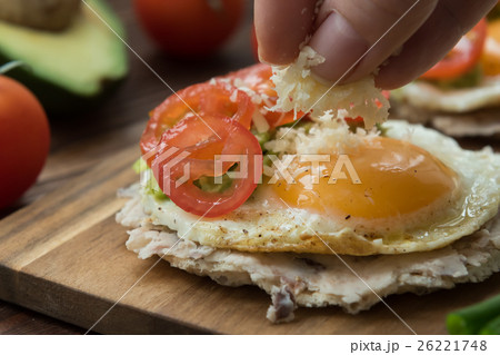 Huevos rancheros tostadas with avocado salsa 26221748