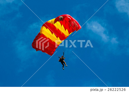 Skydiver and colorful parachute on blue sky  26222526