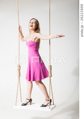 beautiful blond woman on swing against white beautiful blond woman on swing against white 26223899