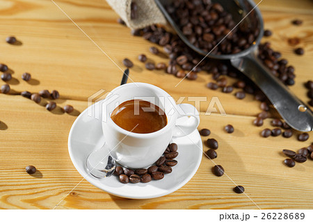 Cup of coffee, bag and scoop on old wooden Cup of coffee, bag and scoop on old wooden 26228689