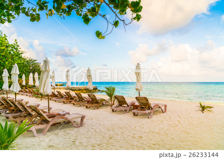 Beach chairs with umbrella at Maldives island, white sandy beach and sea . Beach chairs with umbrella at Maldives island, white sandy beach and sea . 26233144