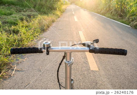 Front handle bar stem biking on rural road Front handle bar stem biking on rural road 26240176