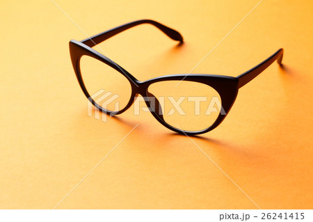 Brown glasses on orange background Brown glasses on orange background 26241415