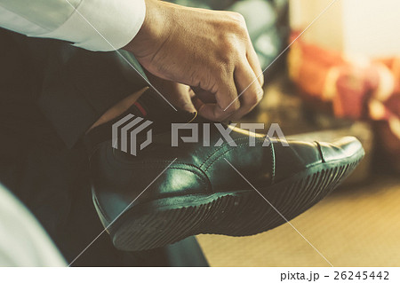 businessman or groom tied a shoelace on his shoes. 26245442
