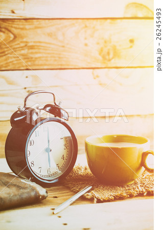 coffee with retro clock on wood table background 26245493