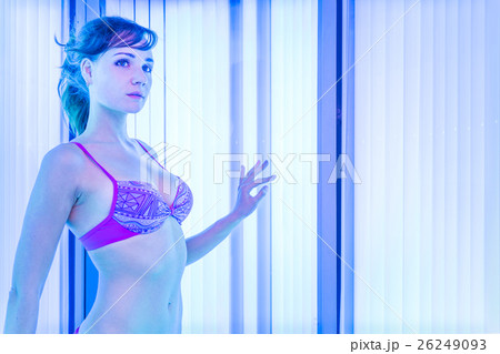 Slim woman in solarium getting sun tan Slim woman in solarium getting sun tan 26249093