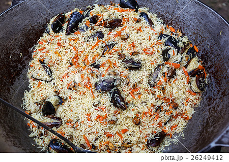 Cooking pilaf with mussels dish in a cauldron 26249412