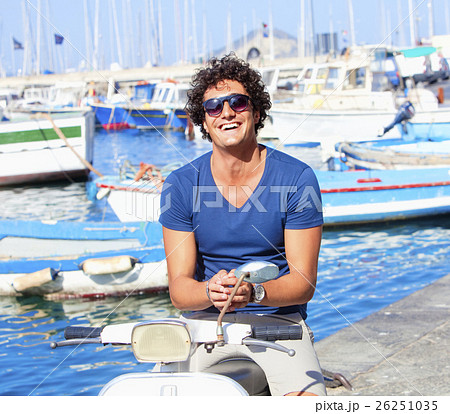 Young Italian Man on Vespa Scooter Smiling Young Italian Man on Vespa Scooter Smiling 26251035