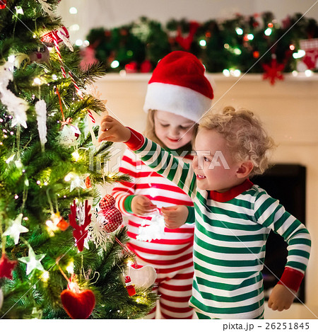 Kids in pajamas under Christmas tree Kids in pajamas under Christmas tree 26251845