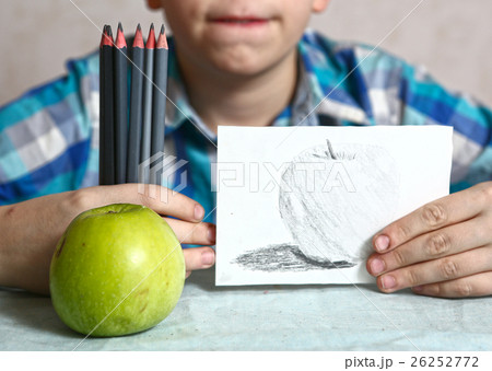 apple and drawing in kids hands apple and drawing in kids hands 26252772