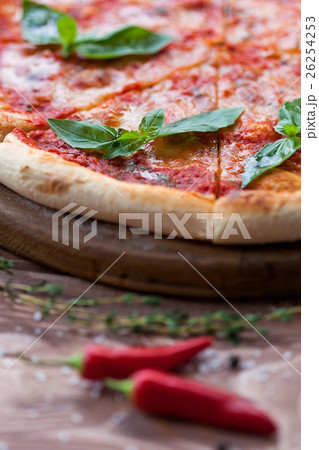 Italian pizza with basil leaves Italian pizza with basil leaves 26254253
