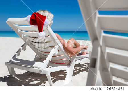 Happy woman in Santa Helper Hat lie on sunbed 26254881