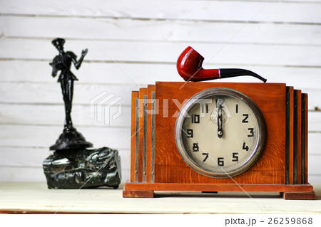 old clock and smoking pipe old clock and smoking pipe 26259868