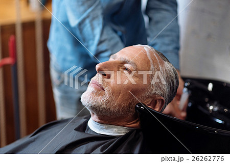 Old man during washing his hair in barber shop Old man during washing his hair in barber shop 26262776