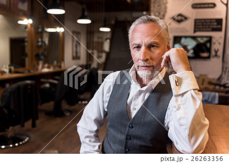 Old man sitting at bar counter and looking forward Old man sitting at bar counter and looking forward 26263356