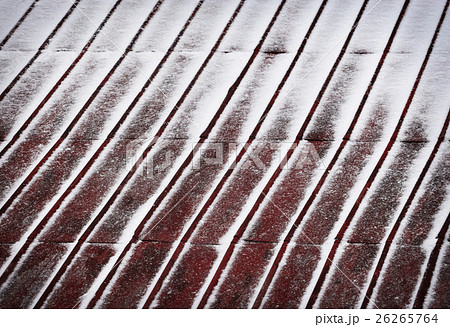 red metal roof dusted with snow 26265764