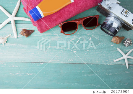 Summer travel beach accessories on wooden board. 26272904