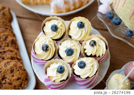 Table with cupcakes, cookies, cakepops and horn 26274196