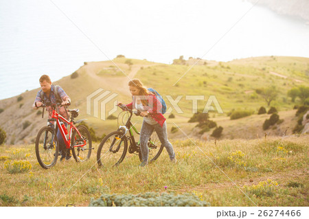 young couple riding bikes in the mountains young couple riding bikes in the mountains 26274466