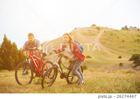 young couple riding bikes in the mountains young couple riding bikes in the mountains 26274467