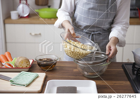 大豆を浸けた水を捨てる女性 26277645