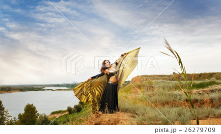 Girl dancing with golden wings. Girl dancing with golden wings. 26279709